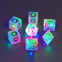 Set of 7 lit Aurora Sky dice with a rainbow of colors across all faces. Set Includes: 1 D20, 3 D8, 3 D6. Aurora Sky colorway is a mostly translucent white resin base packed with small blue and silver glitter throughout. The numbers or symbols are painted metallic black.