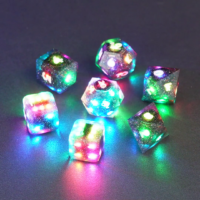 Set of 7 lit Midnight Galaxy dice with a rainbow of colors across all faces. Set Includes: 1 D20, 1 D12, 1 D10, 1 D8, 2 Pipped D6, 1 D4. Midnight Galaxy colorway is a mostly translucent dark smoke black resin base packed with rainbow glitter of various sizes. The numbers or symbols are painted pearl white.